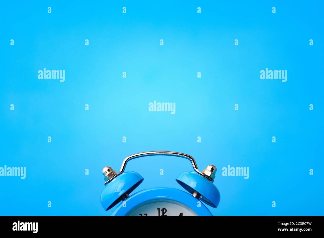 Close-up of an alarm clock, above it an empty place Stock Photo