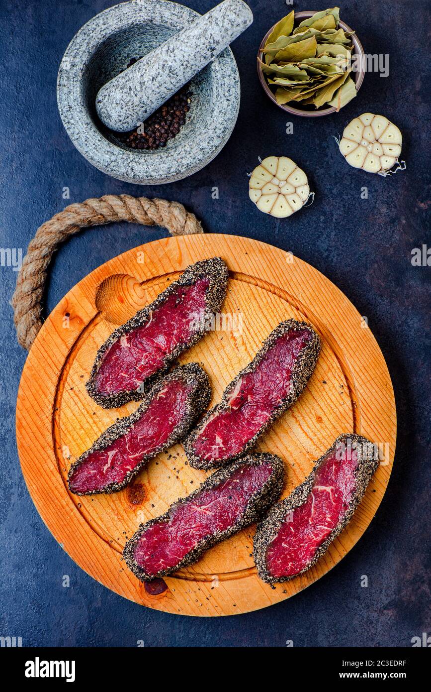 Pepper steaks on wooden cutting board Stock Photo