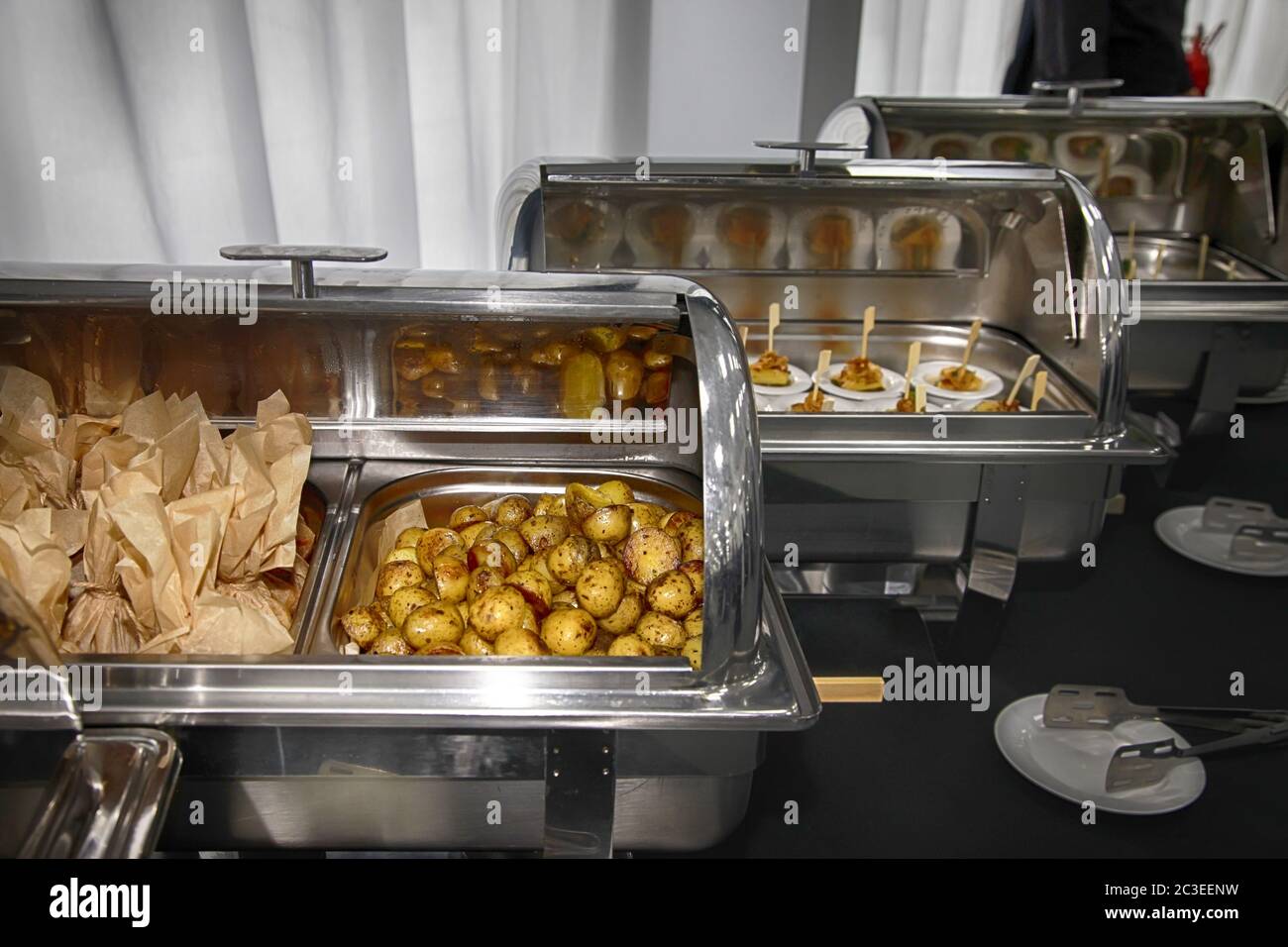 Catering buffet food with heated trays ready for service Stock Photo
