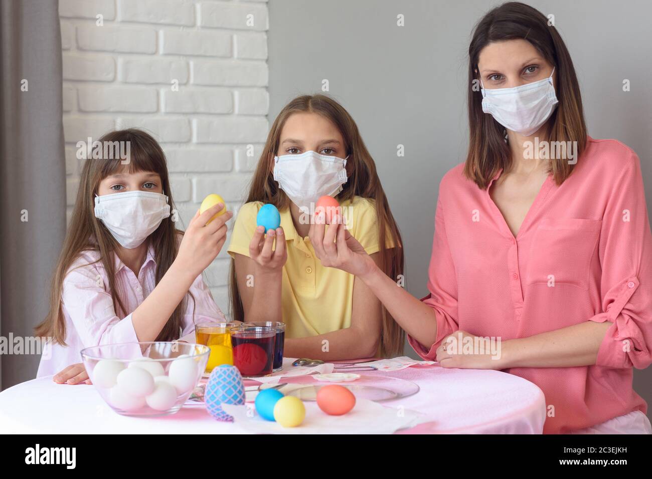 quarantined family paints eggs for easter Stock Photo