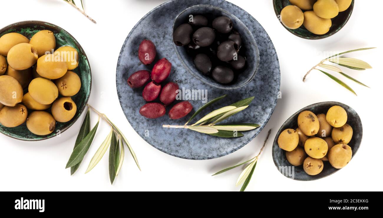 Olives overhead panorama on a white background. Green, black and red olives, shot from above Stock Photo