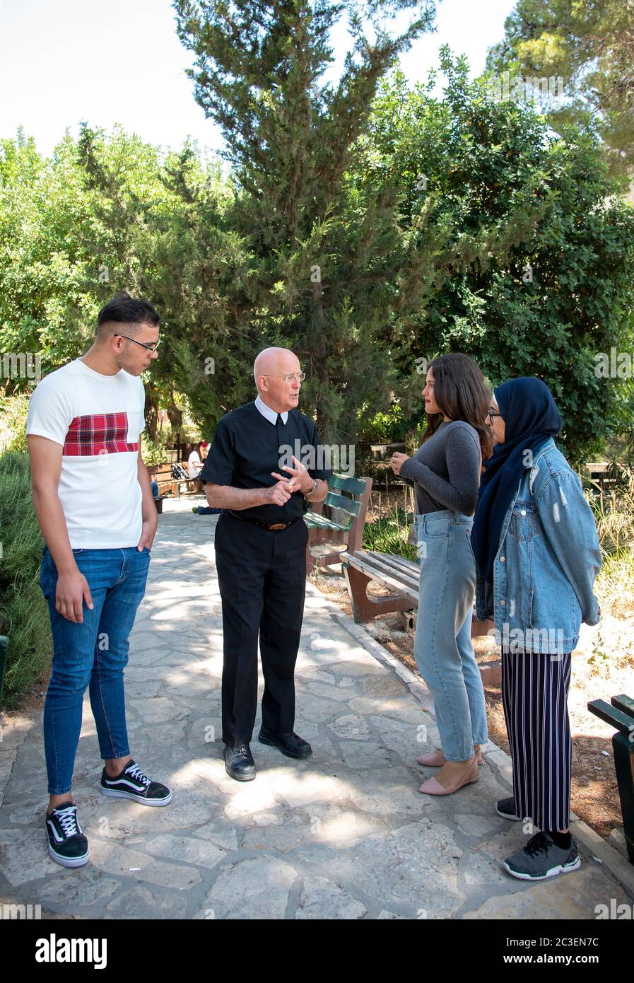 Brother Peter Bray who is the Vice Chancellor of Bethlehem University talking with some of his students on the campus. Stock Photo