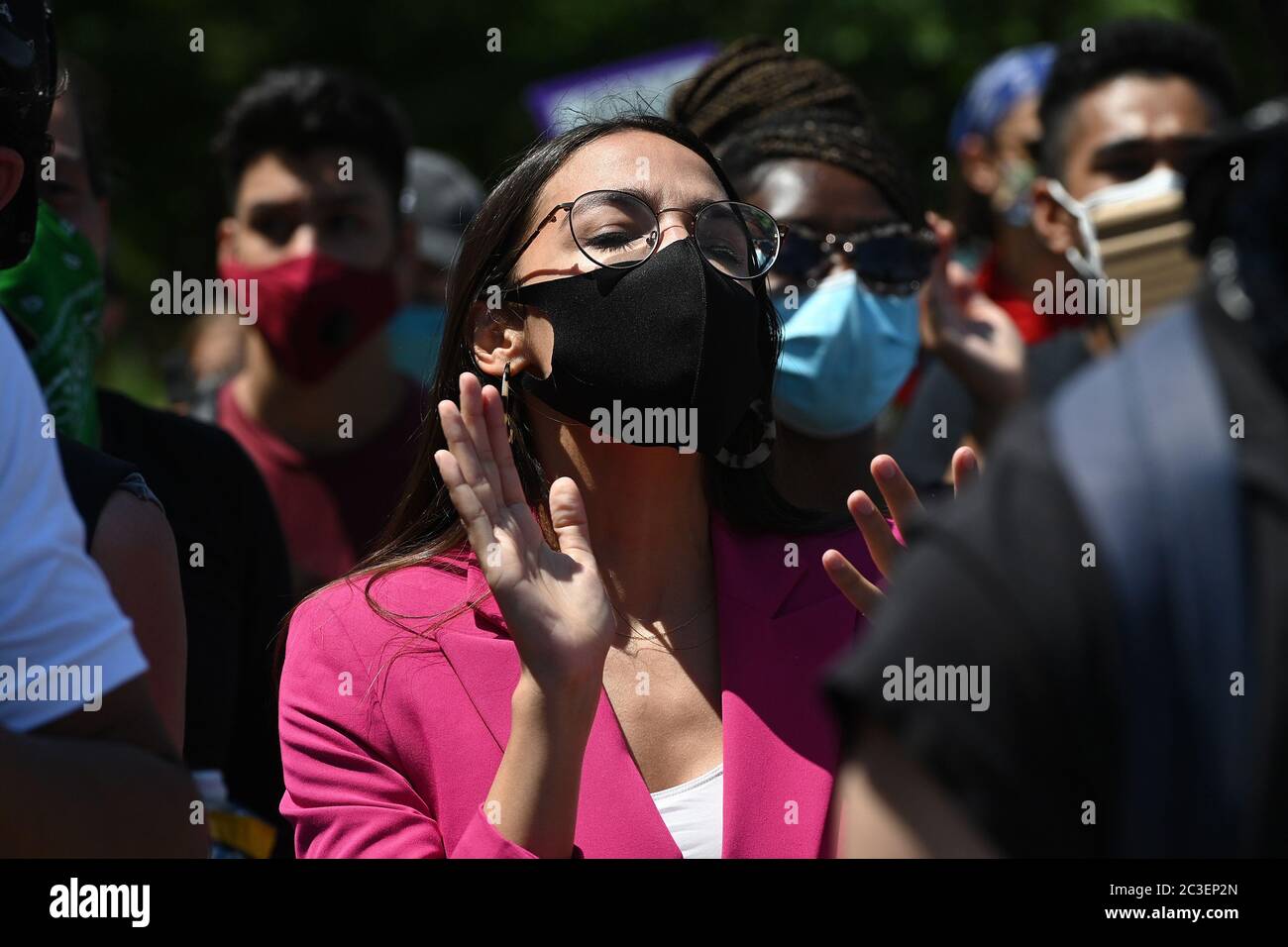 Wearing a mask in the time of COVID-19, U.S. Representative Alexandria Ocasio-Cortez (purple) attends a Juneteenth celebration rally in front of the Unisphere in Flushing Meadows-Corona Park in the borough of Queens, New York, June 19, 2020. Juneteenth is celebrated as a commemoration of the ending of slavery in the United States.   gi Credit: Sipa USA/Alamy Live News Stock Photo