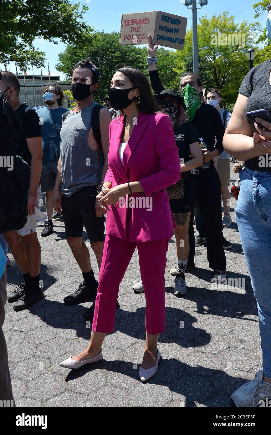 Wearing a mask in the time of COVID-19, U.S. Representative Alexandria Ocasio-Cortez (purple) attends a Juneteenth celebration rally in front of the Unisphere in Flushing Meadows-Corona Park in the borough of Queens, New York, June 19, 2020. Juneteenth is celebrated as a commemoration of the ending of slavery in the United States.   gi Credit: Sipa USA/Alamy Live News Stock Photo