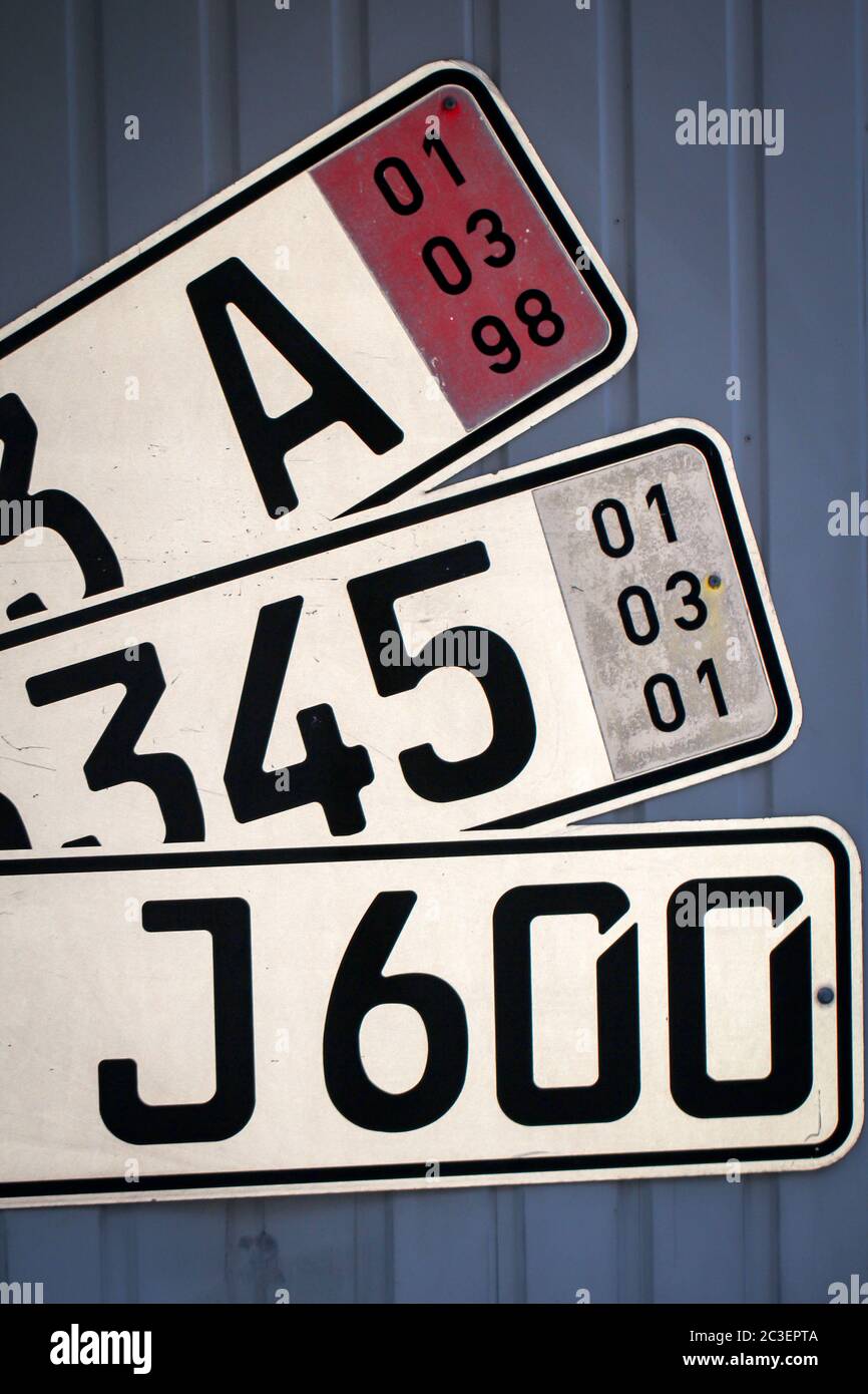 License plates for car vehicles on a wall Stock Photo
