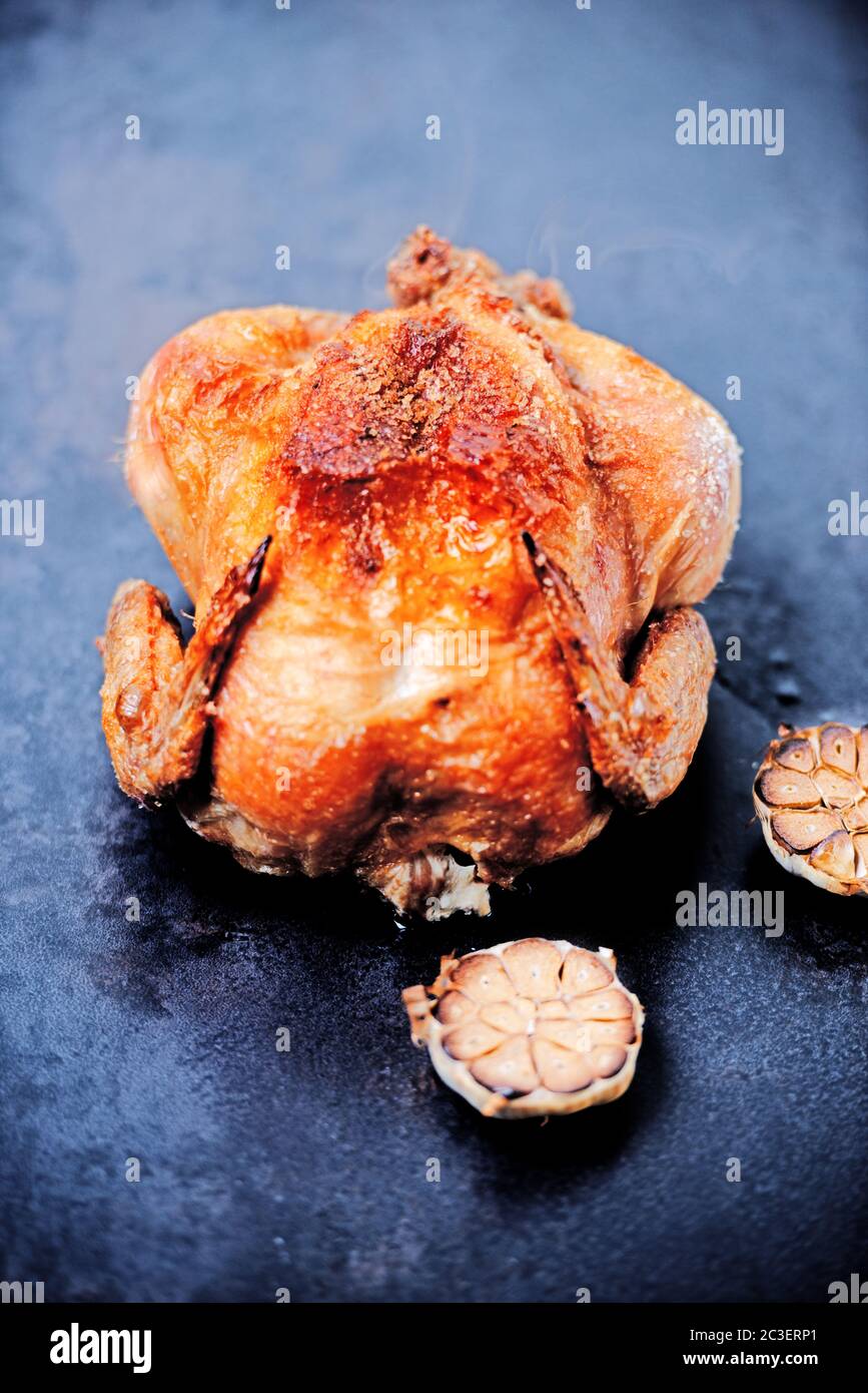 Whole oven roasted chicken with garlic Stock Photo - Alamy