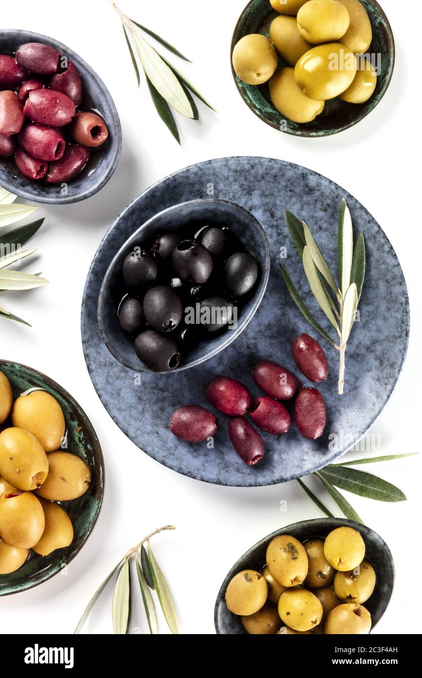 Olives, green, black and red, shot from above on white Stock Photo