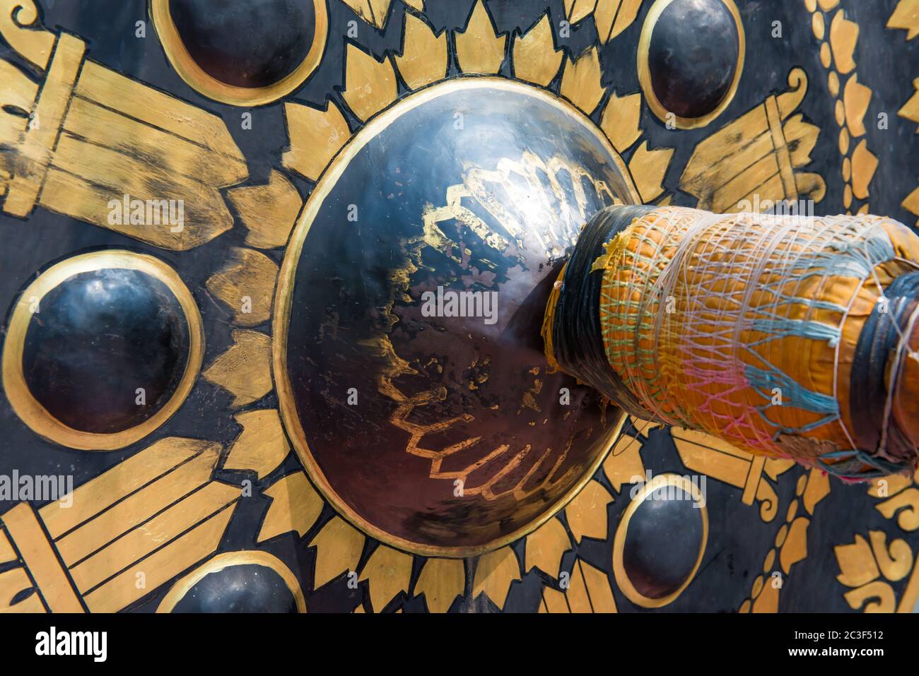 Closeup view of golden and black metal gong in traditional buddhist temple. Sound of buddhism religion Stock Photo