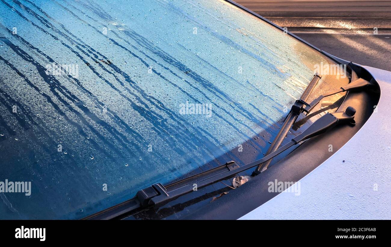 Closeup of windshield wiper covered rain drop in the morning. Stock Photo