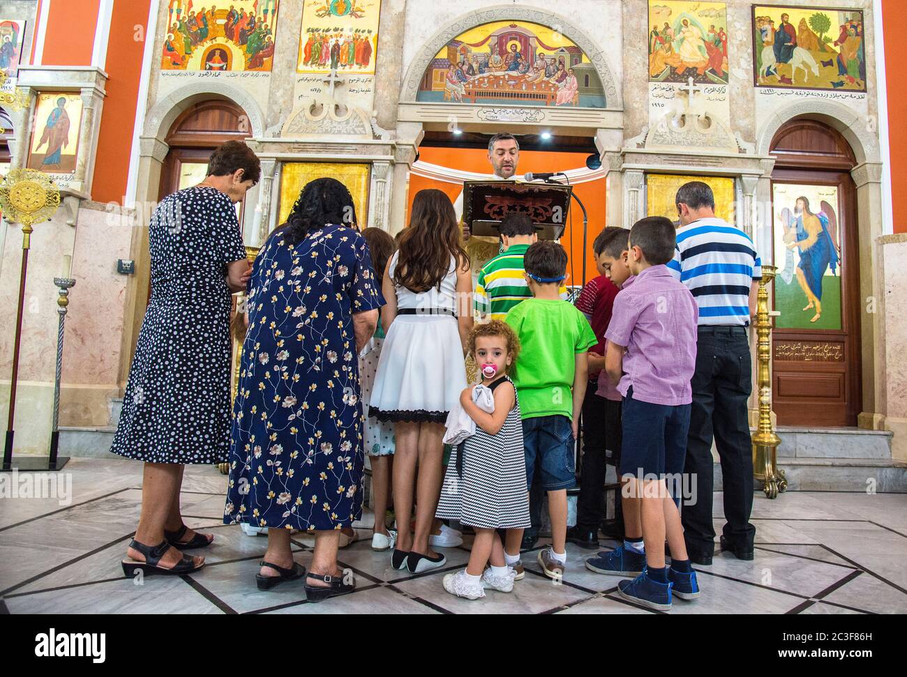 The Rev. Androwas Bahus leads an early morning liturgy at St. Peter and St. Paul Church in the city of Shefa-Amr, Israel. Stock Photo