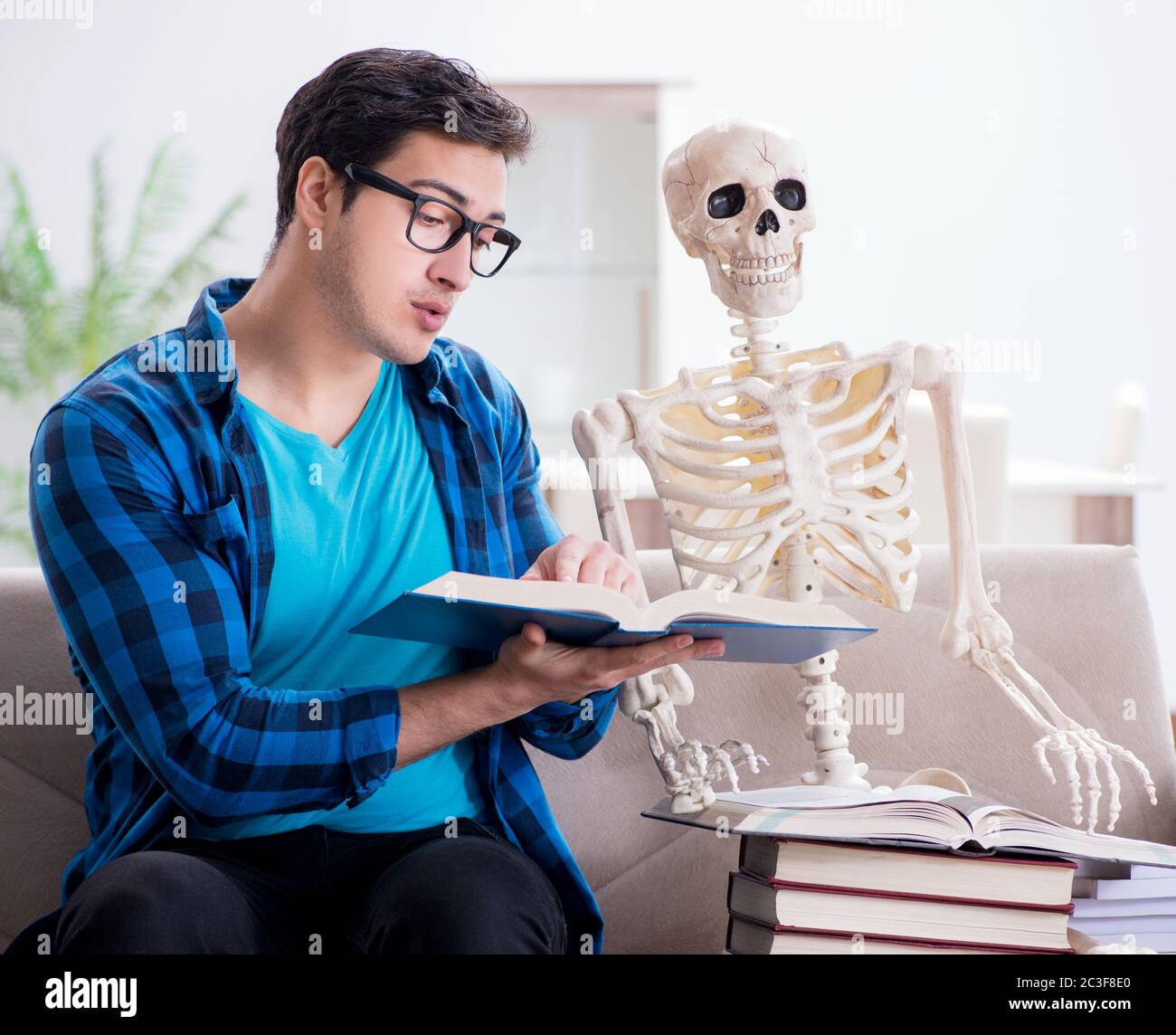 Student studying with skeleton preparing for exams Stock Photo