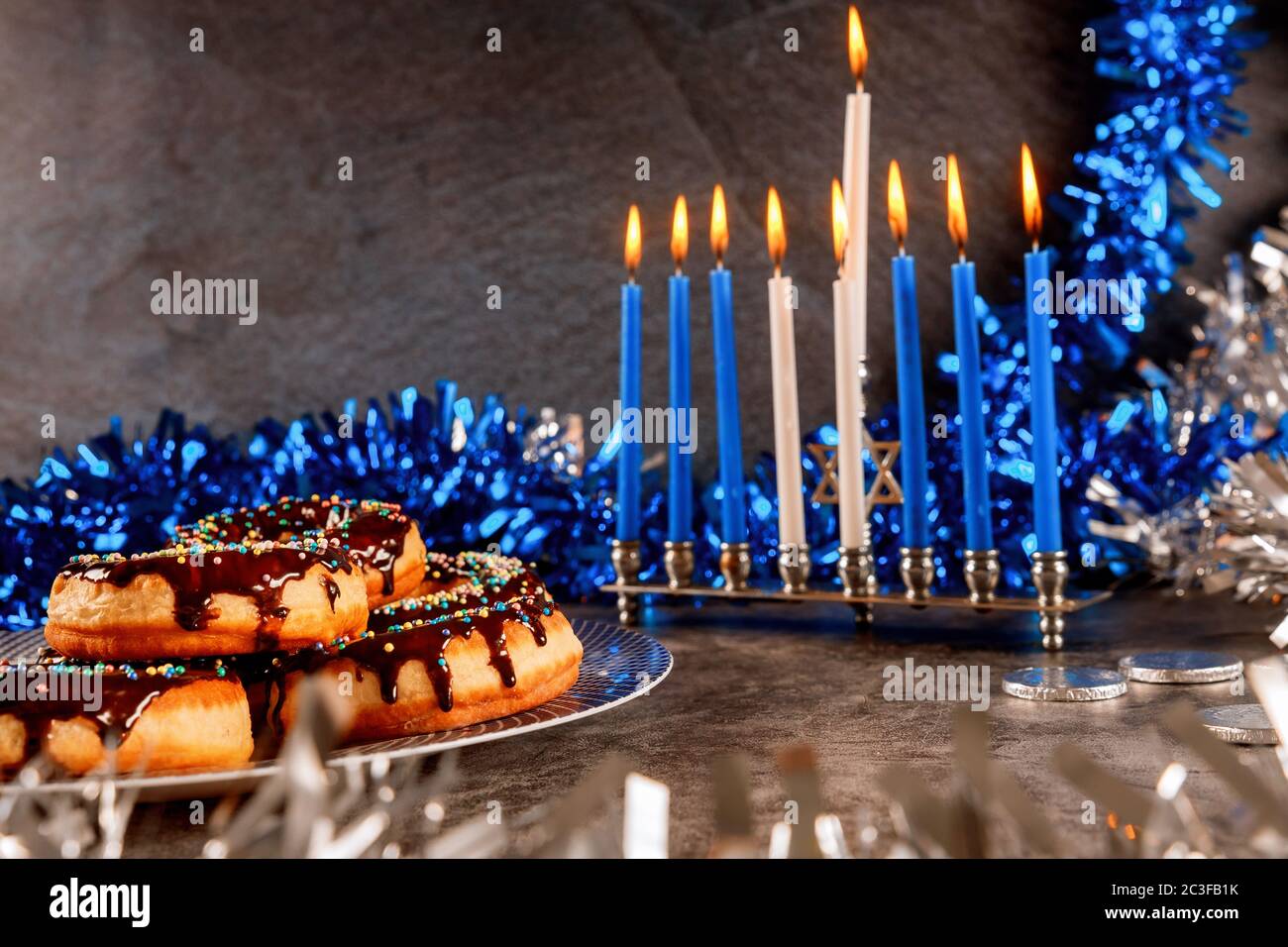 Hanukkah menorah, donuts, chocolate coins and white and blue decoration.  Hanukkah content Stock Photo - Alamy