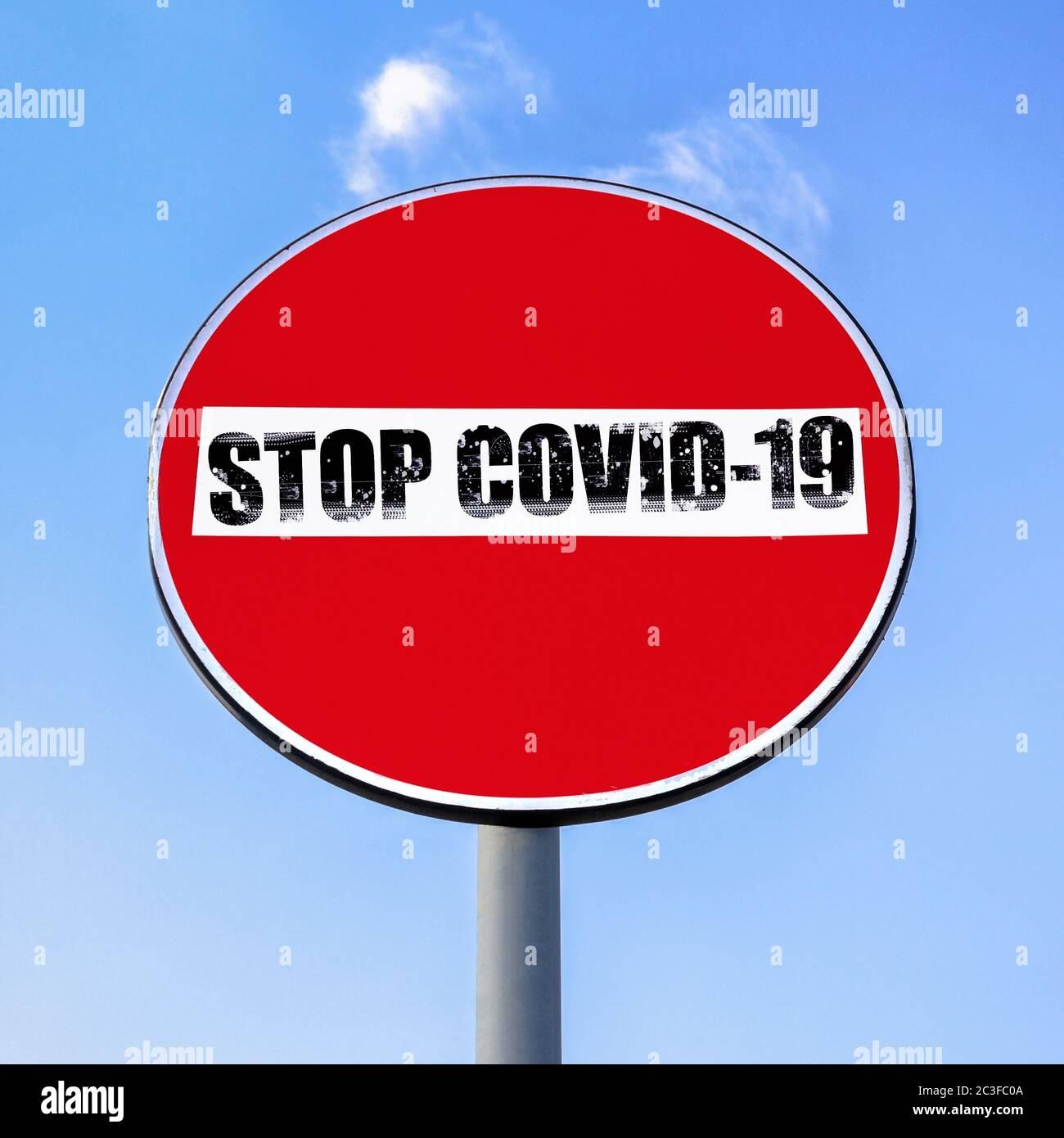 No access denied road sign with message STOP COVID-19 Stock Photo