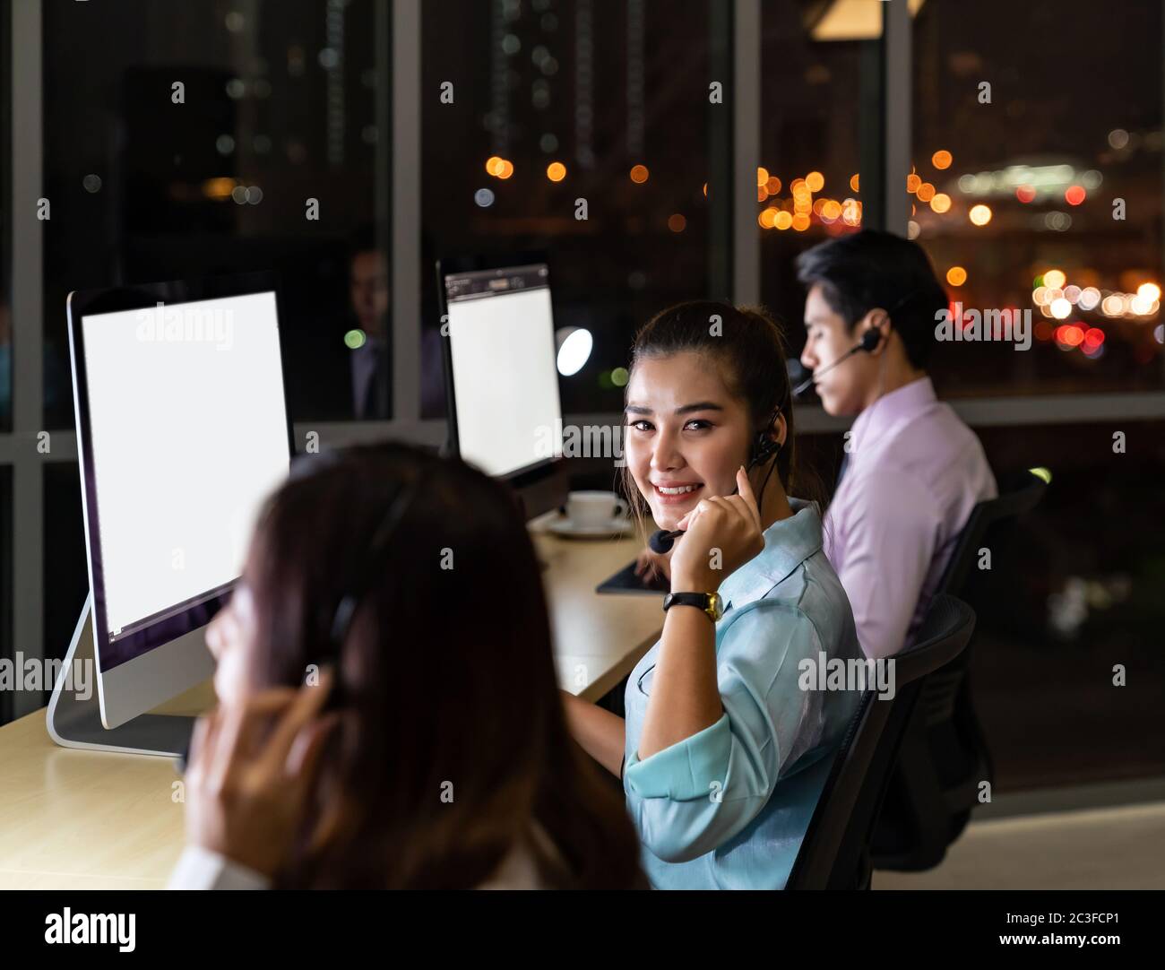 Call Center working at night. Stock Photo