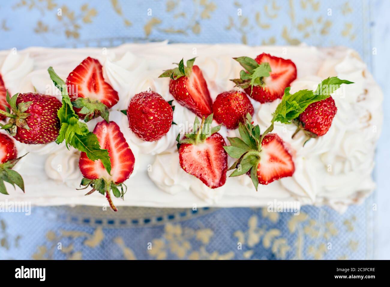 Freshly baked sweet strawberry Long-Cake Roll, also called Strawberry roulade Stock Photo