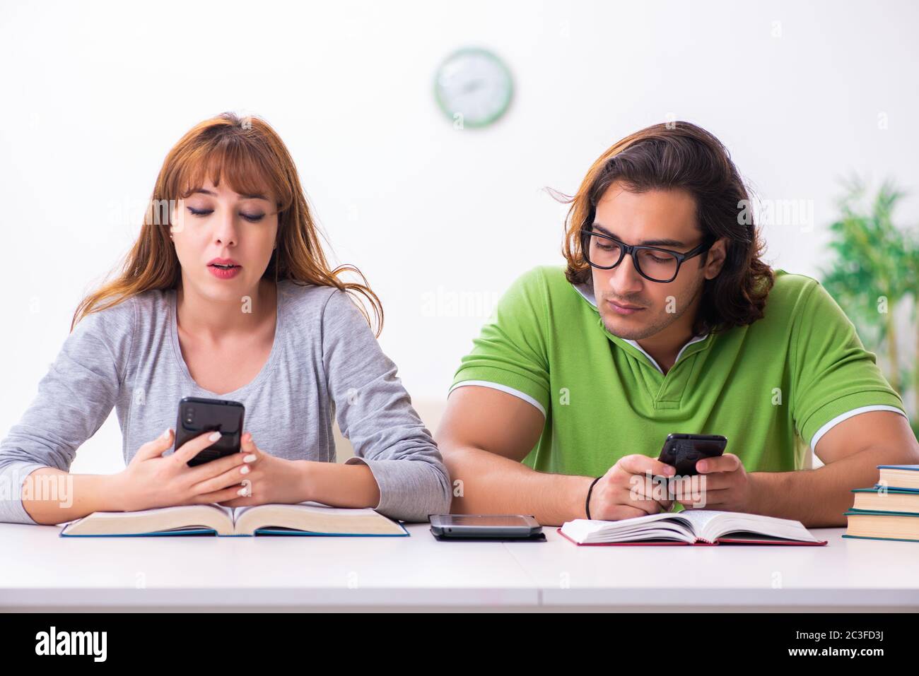 Two students in gadget dependency concept Stock Photo