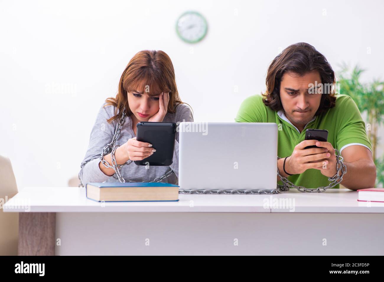Two students in gadget dependency concept Stock Photo