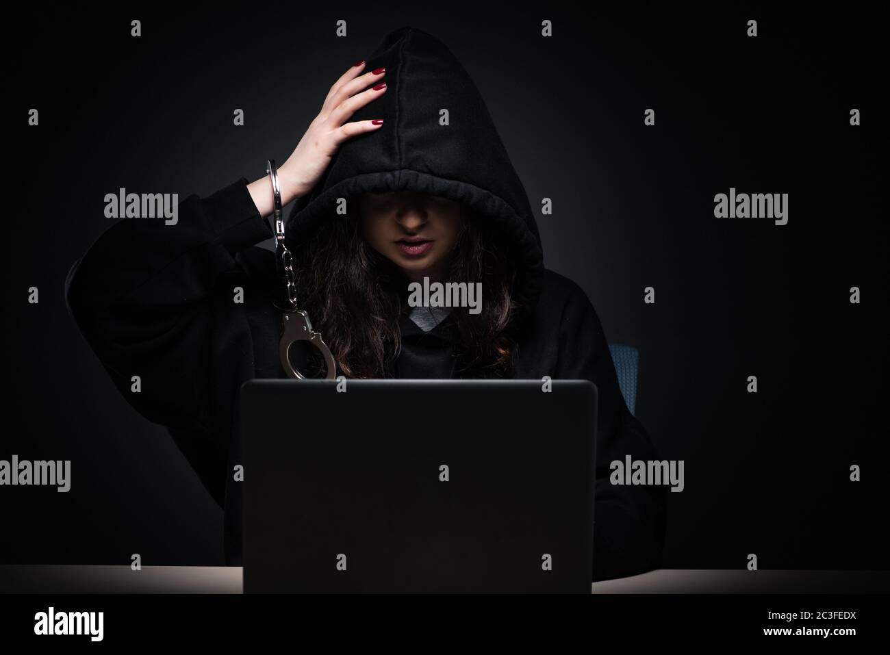 Female hacker hacking security firewall late in office Stock Photo