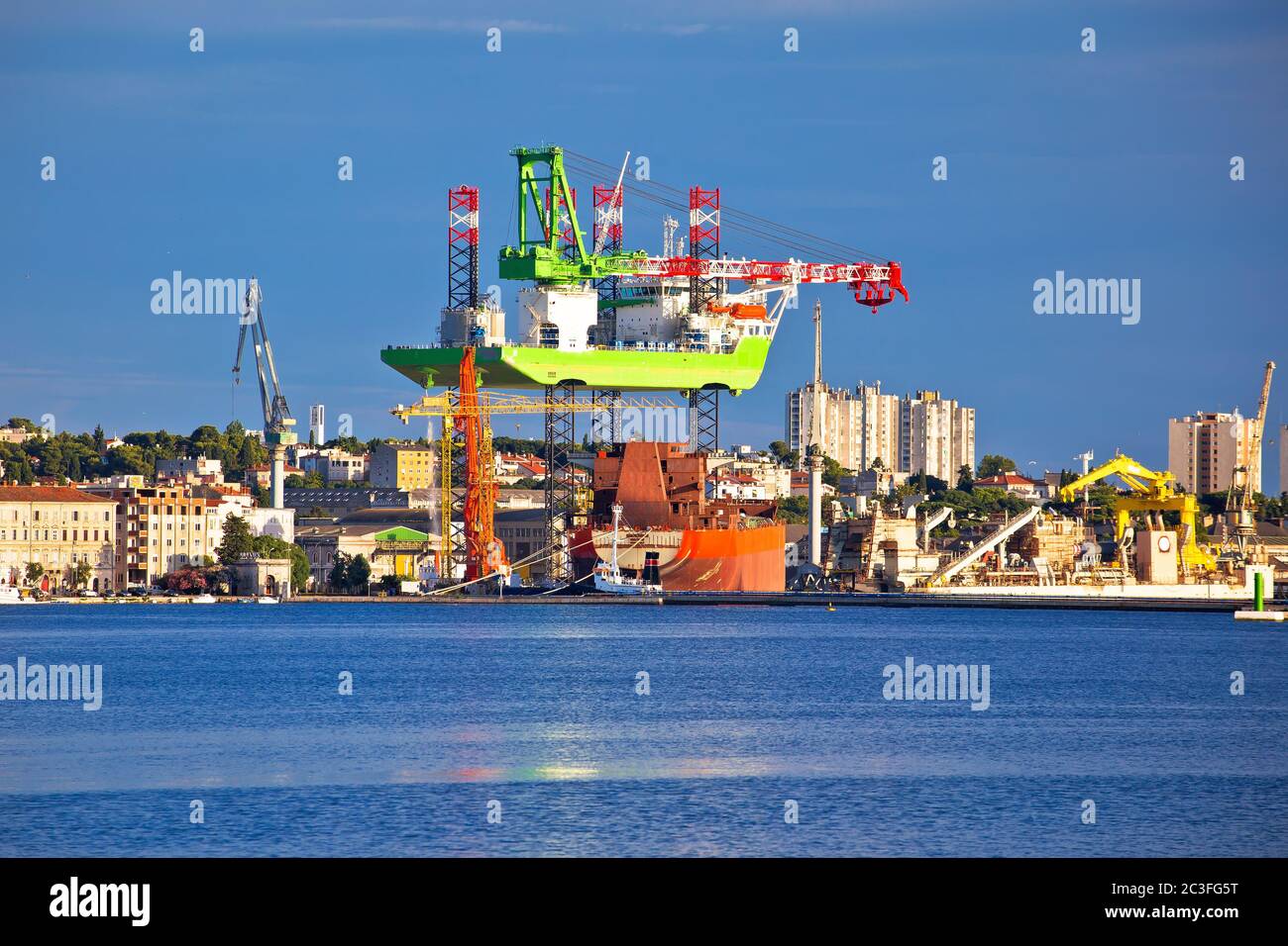 Town of Pula shipyard cranes view from the sea Stock Photo