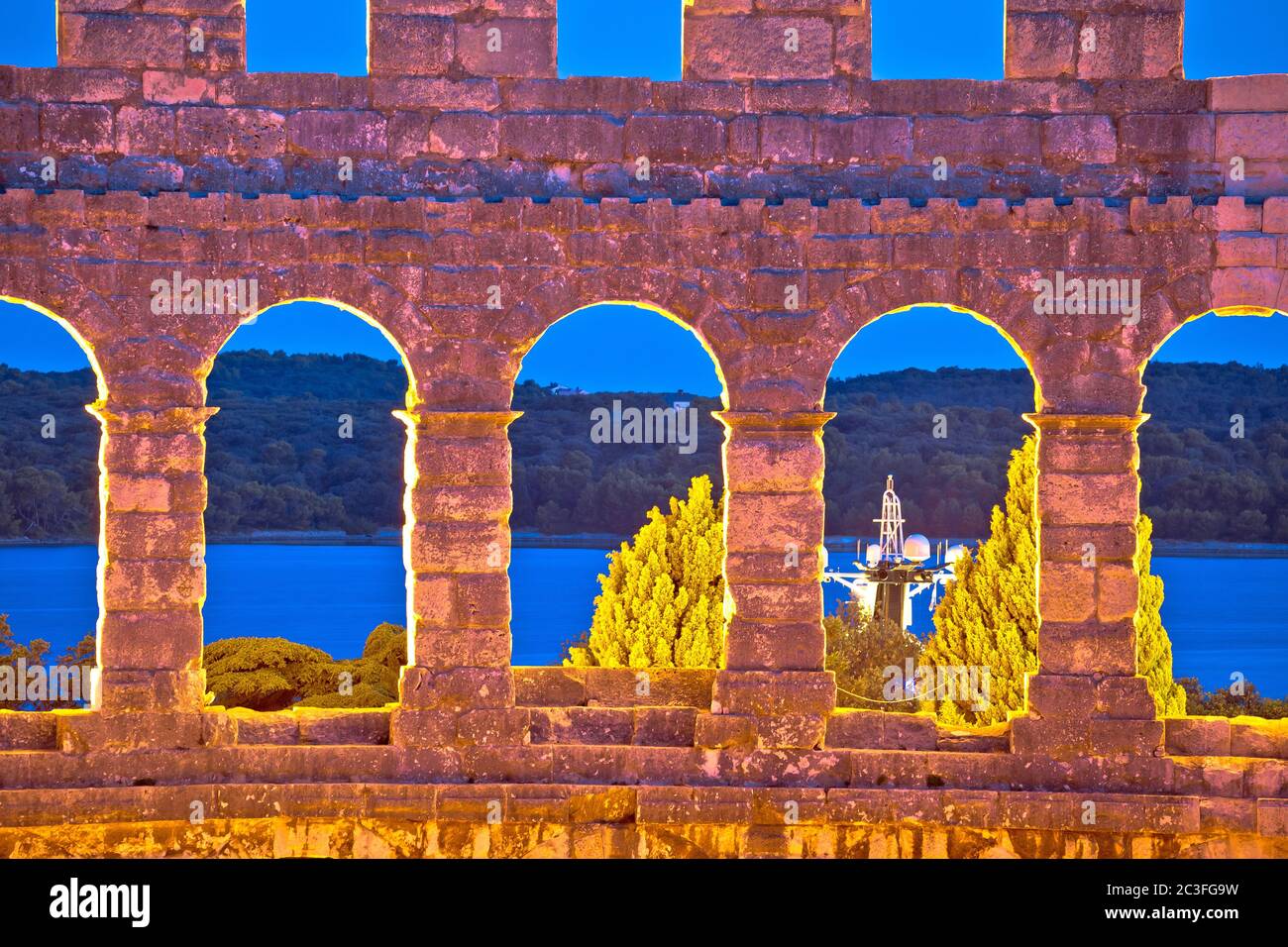 Evening view through walls and arches of Arena Pula Stock Photo