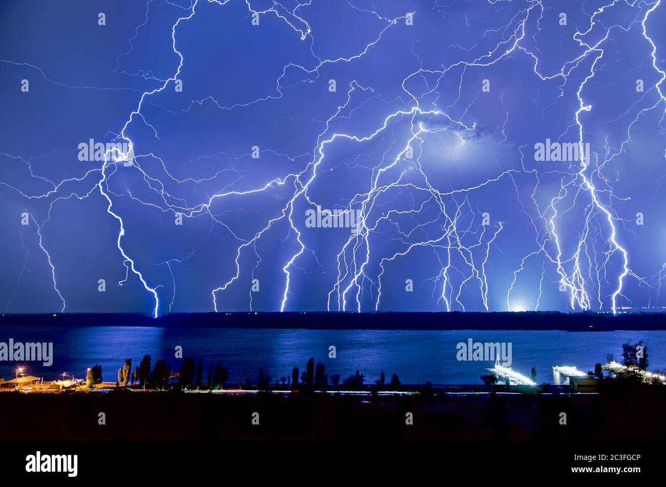 Bright night flash of lightning over the river Stock Photo - Alamy
