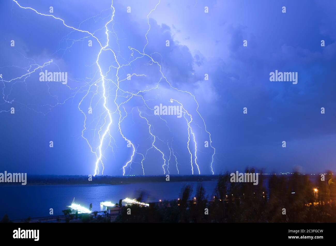 Bright night flash of lightning over the river Stock Photo