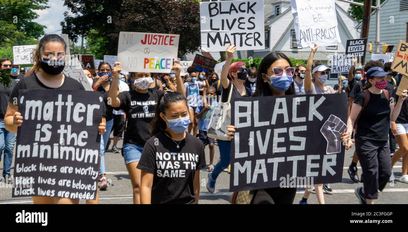 Juneteenth March Black Lives Matter Protest George Floyd - Huge Crowd of protesters marching in the street holding signs for justice black lives matte Stock Photo