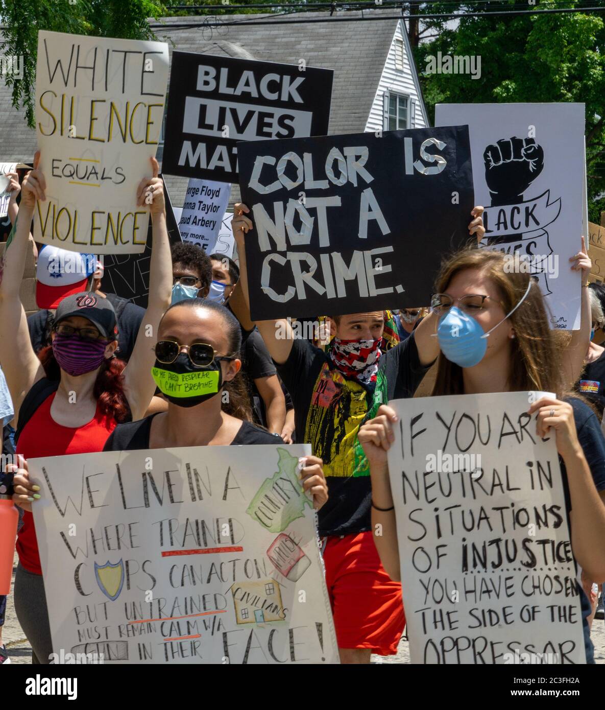 Juneteenth March Black Lives Matter George Floyd Protest - Crowd of Protesters holding up signs in the streets - Color is not a crime - white silence Stock Photo