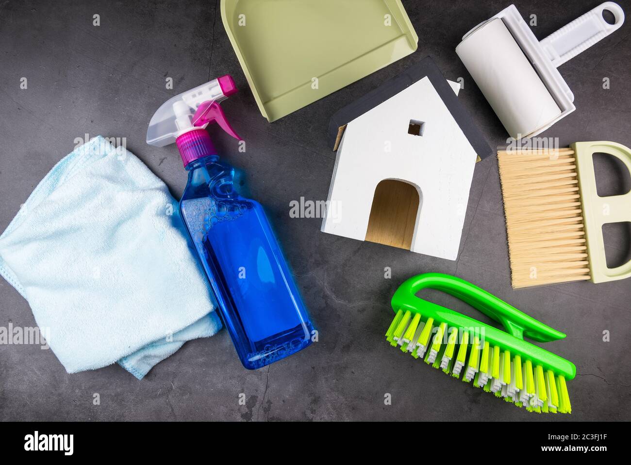 Wooden model white houses and house cleaning equipment on cement gray