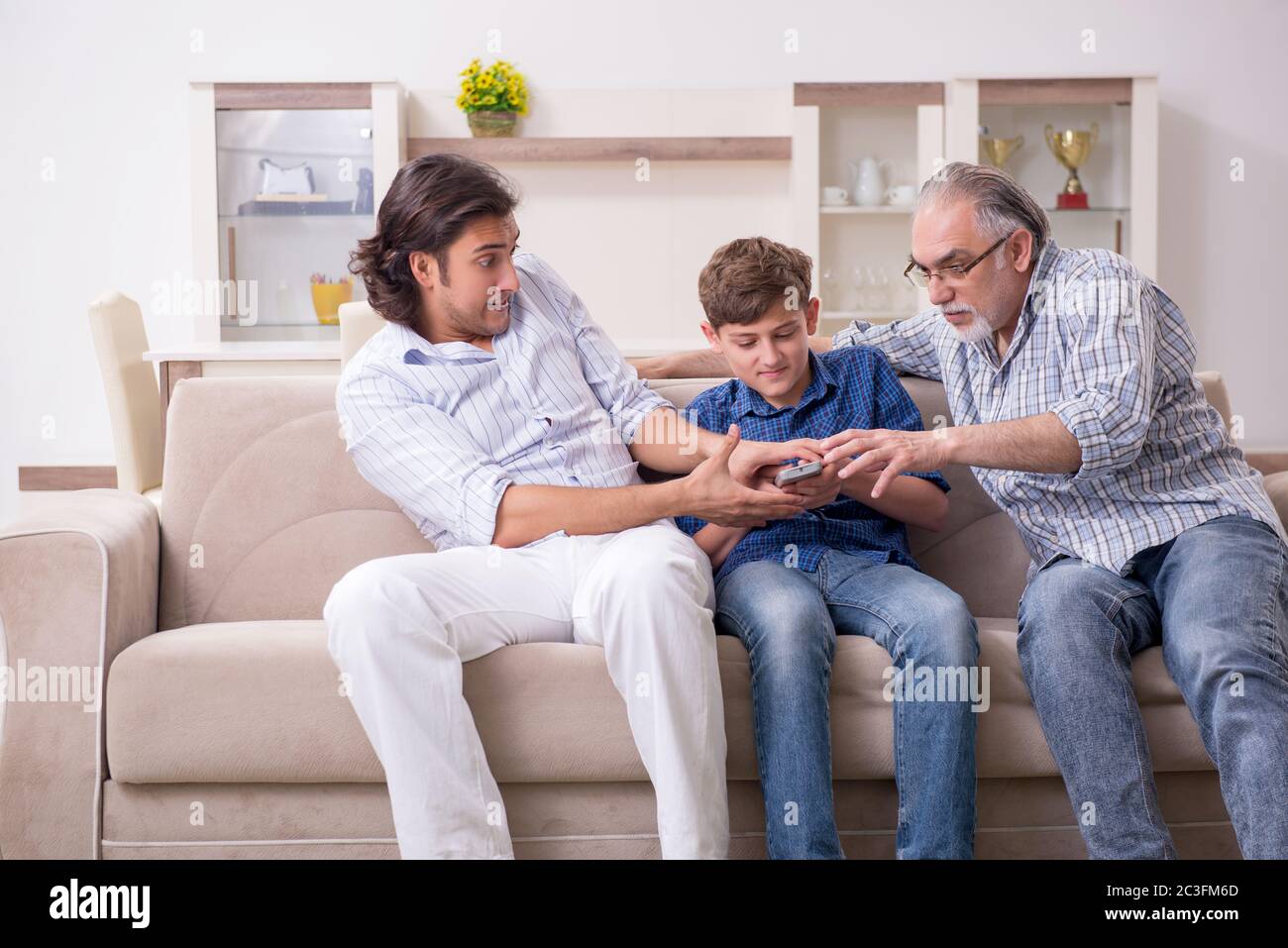 Boy and his father and his grandfother indoor Stock Photo