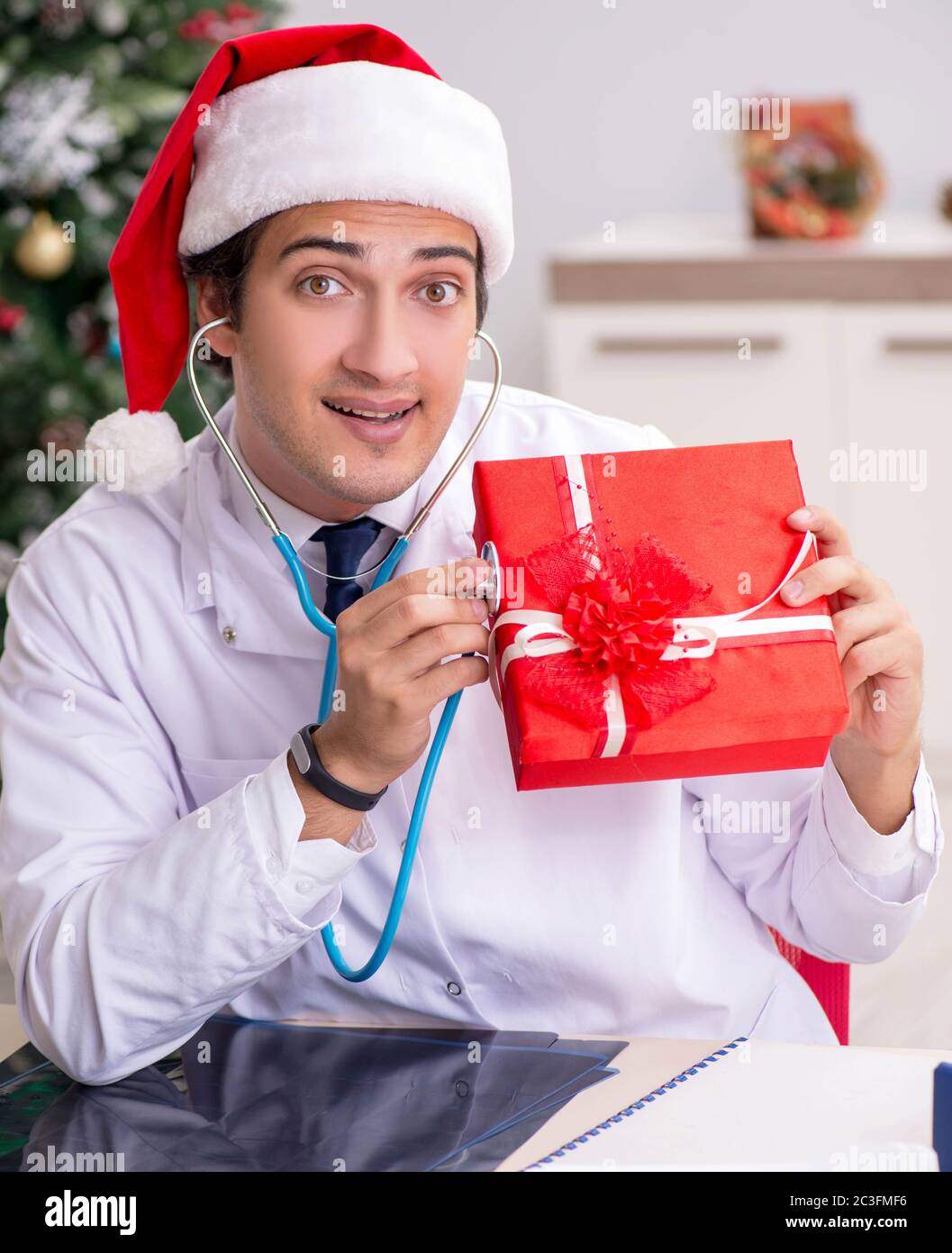 Doctor with gift box in the hospital Stock Photo - Alamy