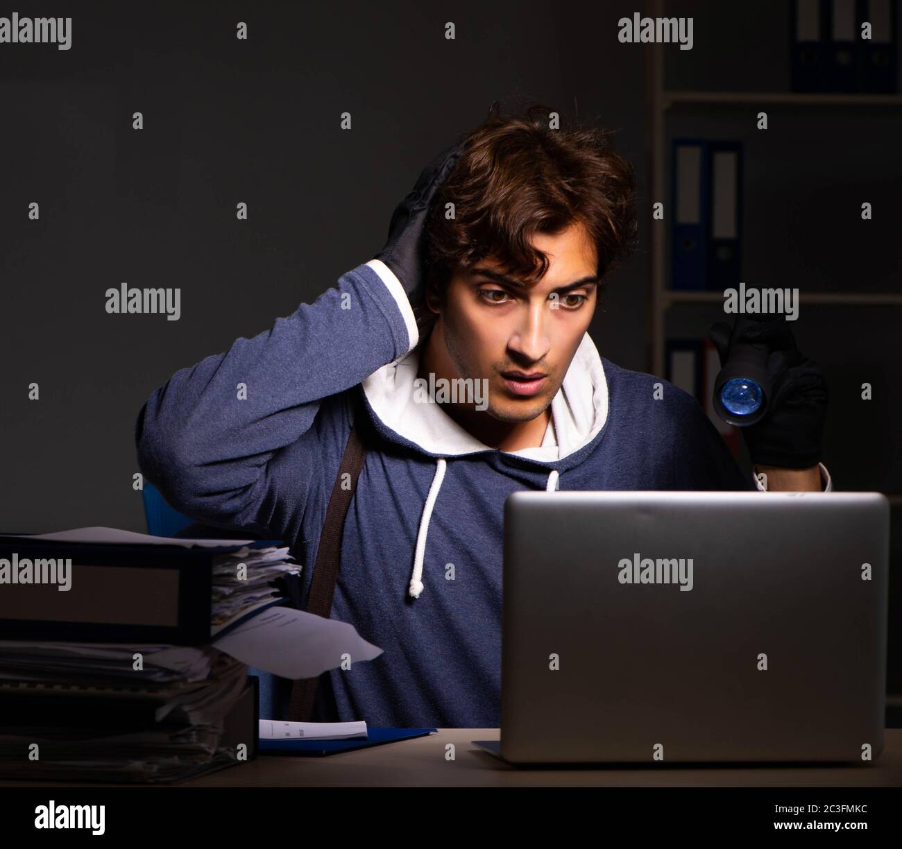 Thief trying to steal personal data in identity theft concept Stock Photo