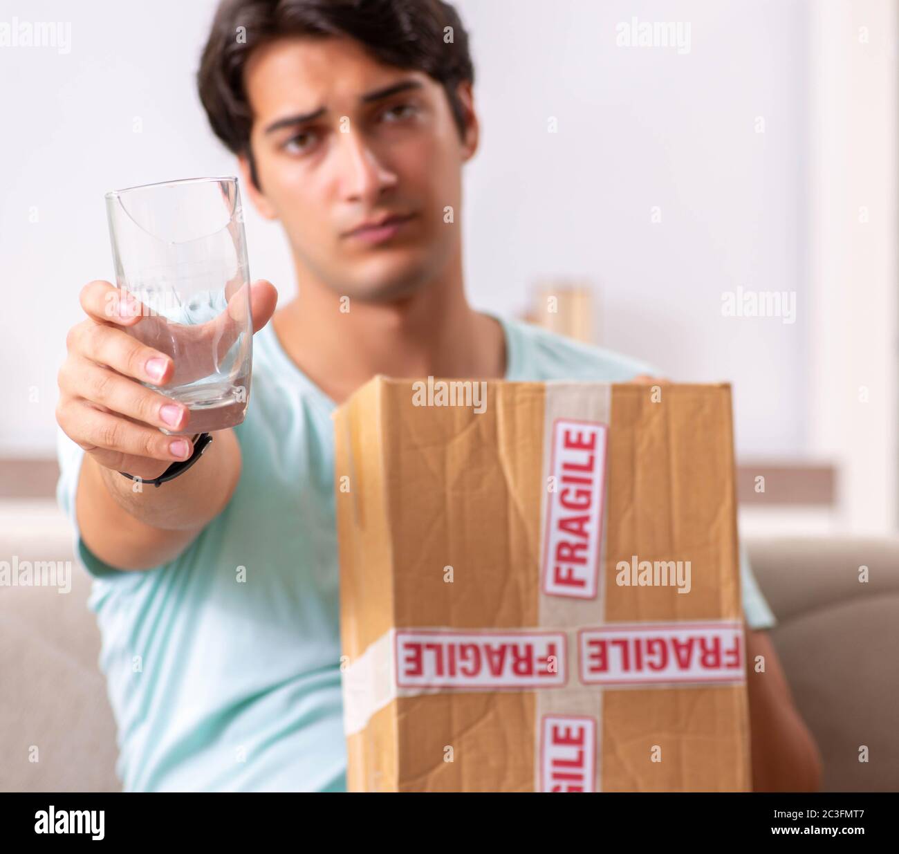 Man opening fragile parcel ordered from internet Stock Photo - Alamy