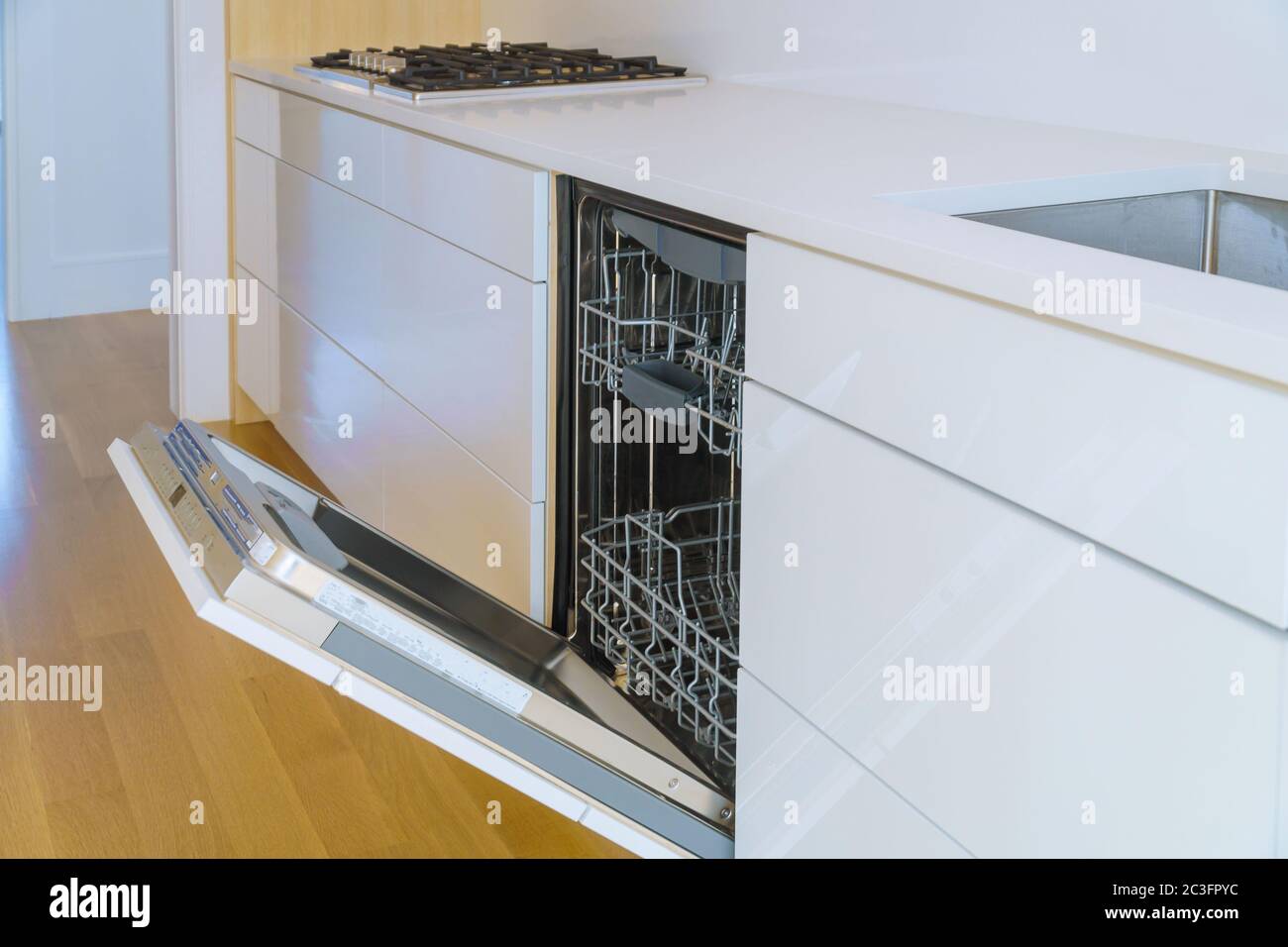 Modern domestic kitchen cabinets with new appliances dishwasher in kitchen Stock Photo
