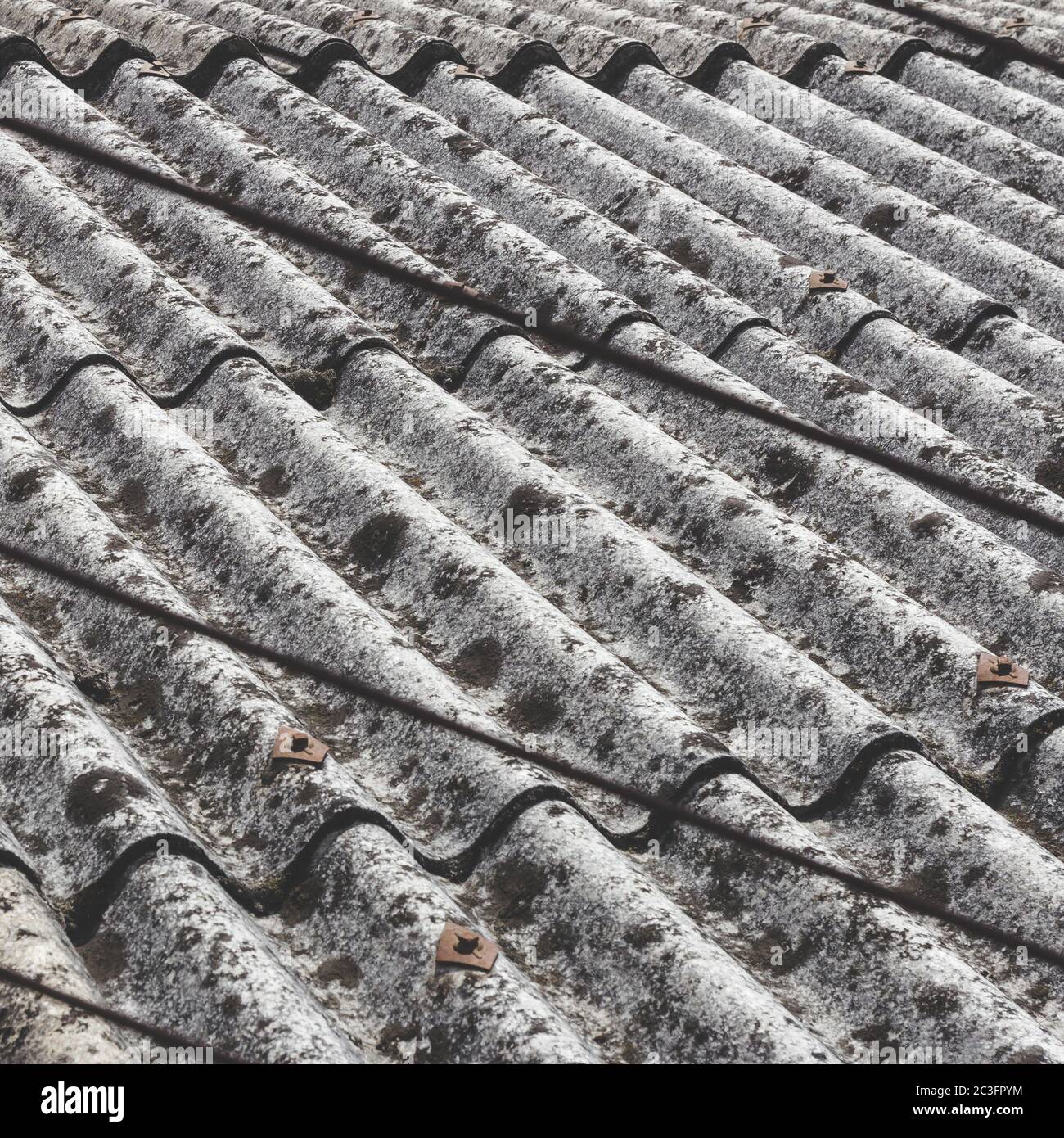 Roofing detail with dangerous asbestos panels Stock Photo