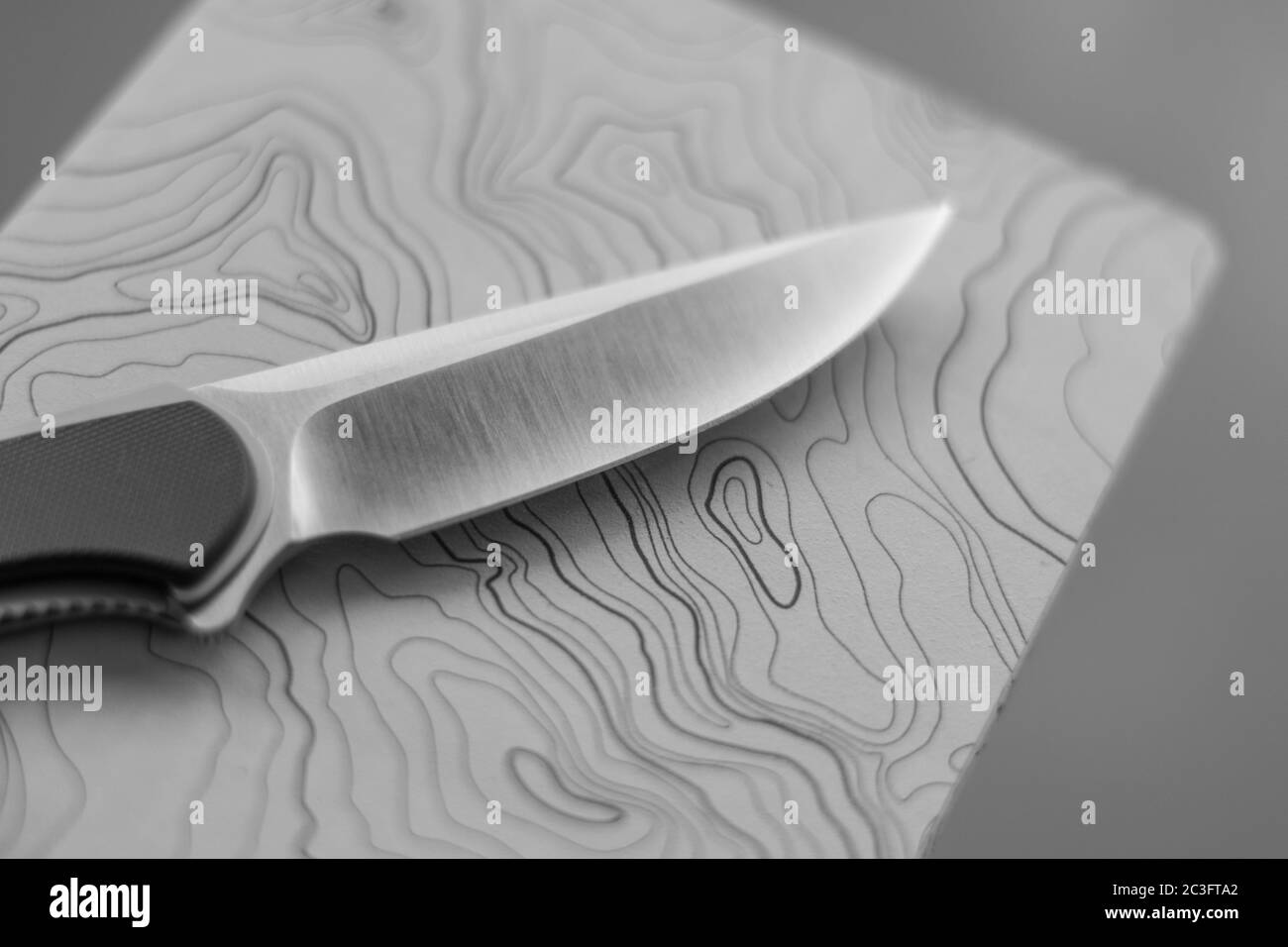 Isolated close up of a single blade knife on a topographic map notebook- Concept camping/ outdoors background- Israel Stock Photo