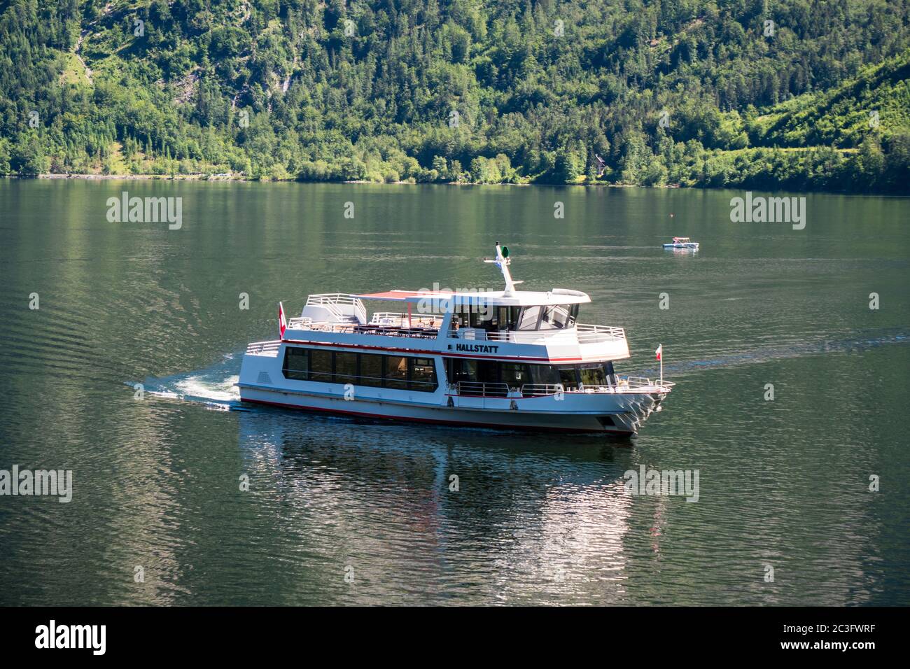 Hallstatt, Austria - June 12 2020: Excursion Cruise Ship Hallstatt Cruising on the Lake Hallstatter See in Summer in the Alps of Austria Stock Photo