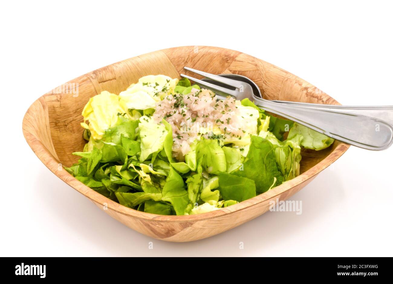 fresh green lettuce salad in a bowl isolated on a white background. Stock Photo