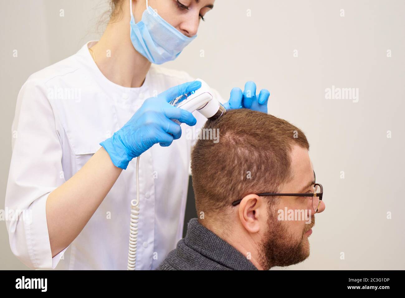 Microscopic examination of the hair and skin of the scalp Stock Photo