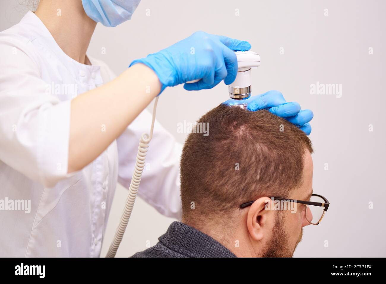 Microscopic examination of the hair and skin of the scalp Stock Photo
