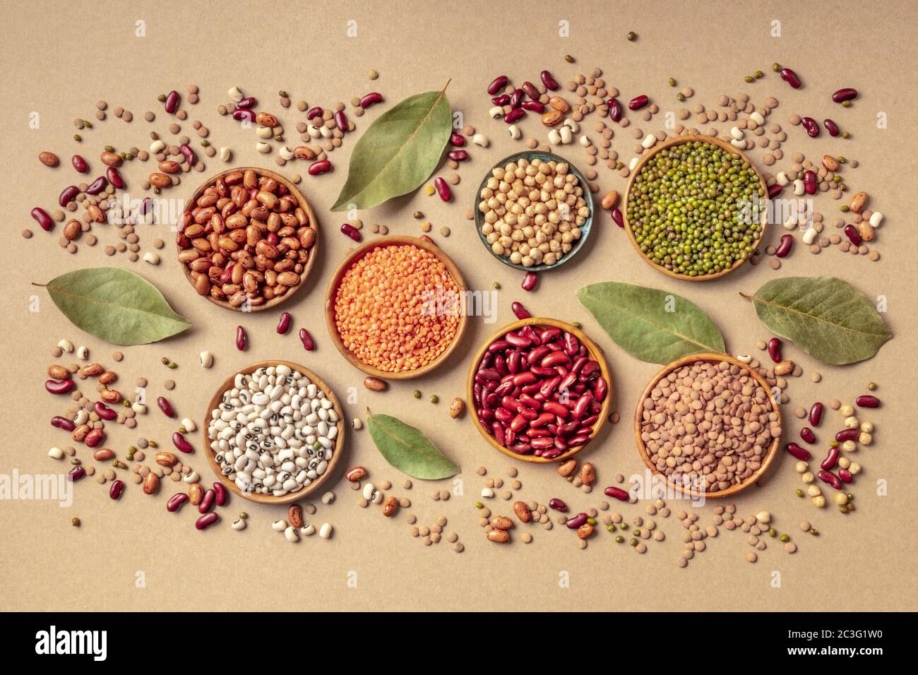 Legumes assortment, shot from the top on a brown background. Lentils, soybeans, chickpeas, red kidney beans, black-eyed peas, a Stock Photo