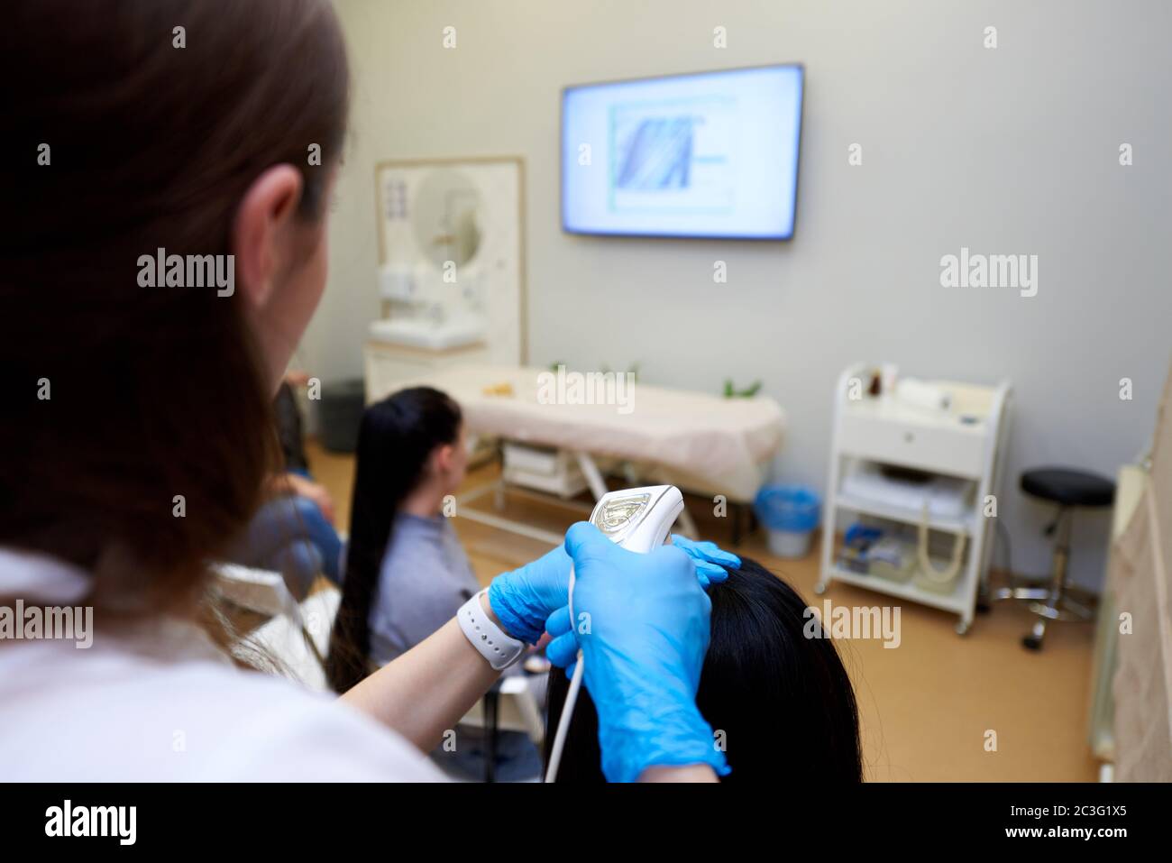 Examination of hair and scalp at a medical training seminar Stock Photo