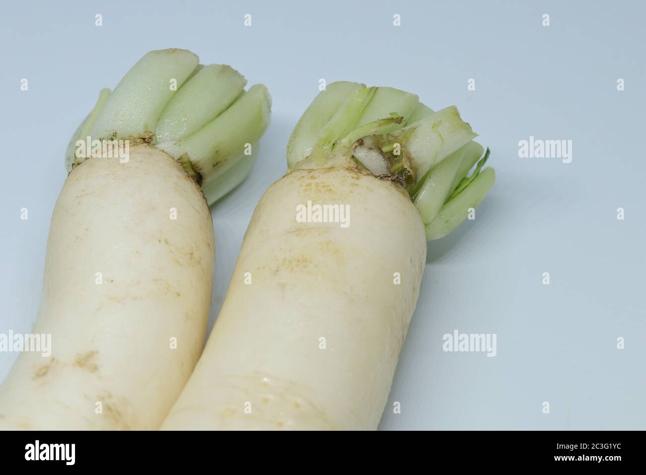 Fresh organic daikon radishes isolated on white background Stock Photo