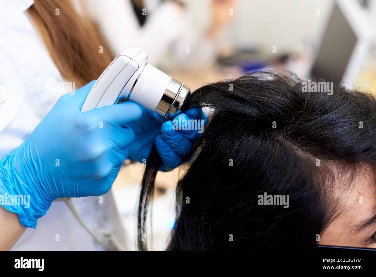 Microscopic examination of the hair and skin of the scalp Stock Photo