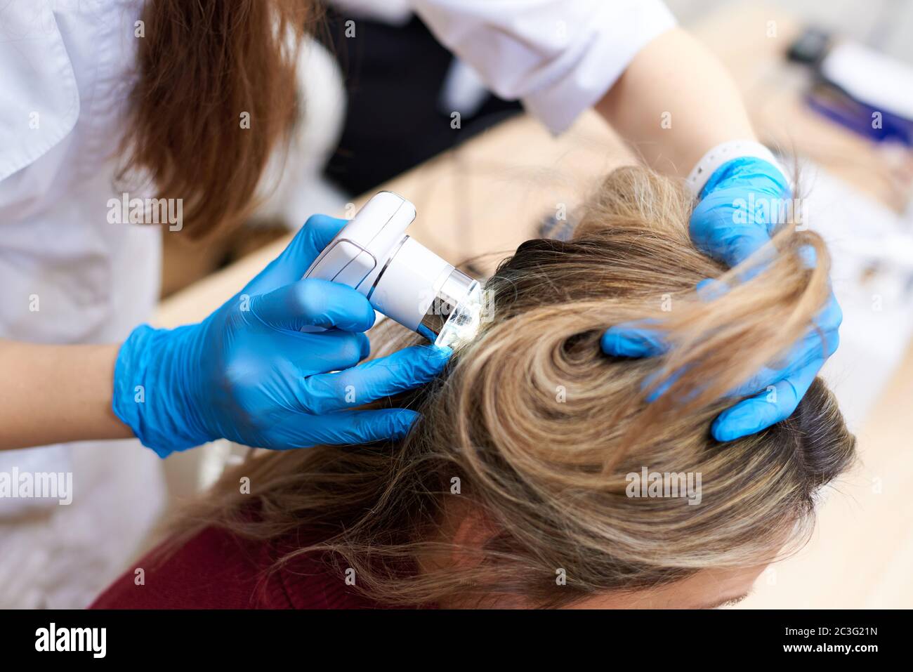 Microscopic examination of the hair and skin of the scalp Stock Photo