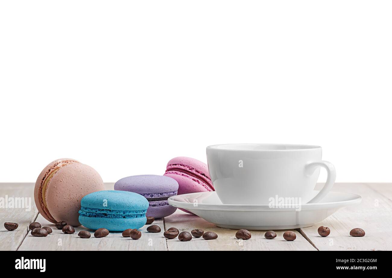 Macaroons with coffee on wooden table Stock Photo