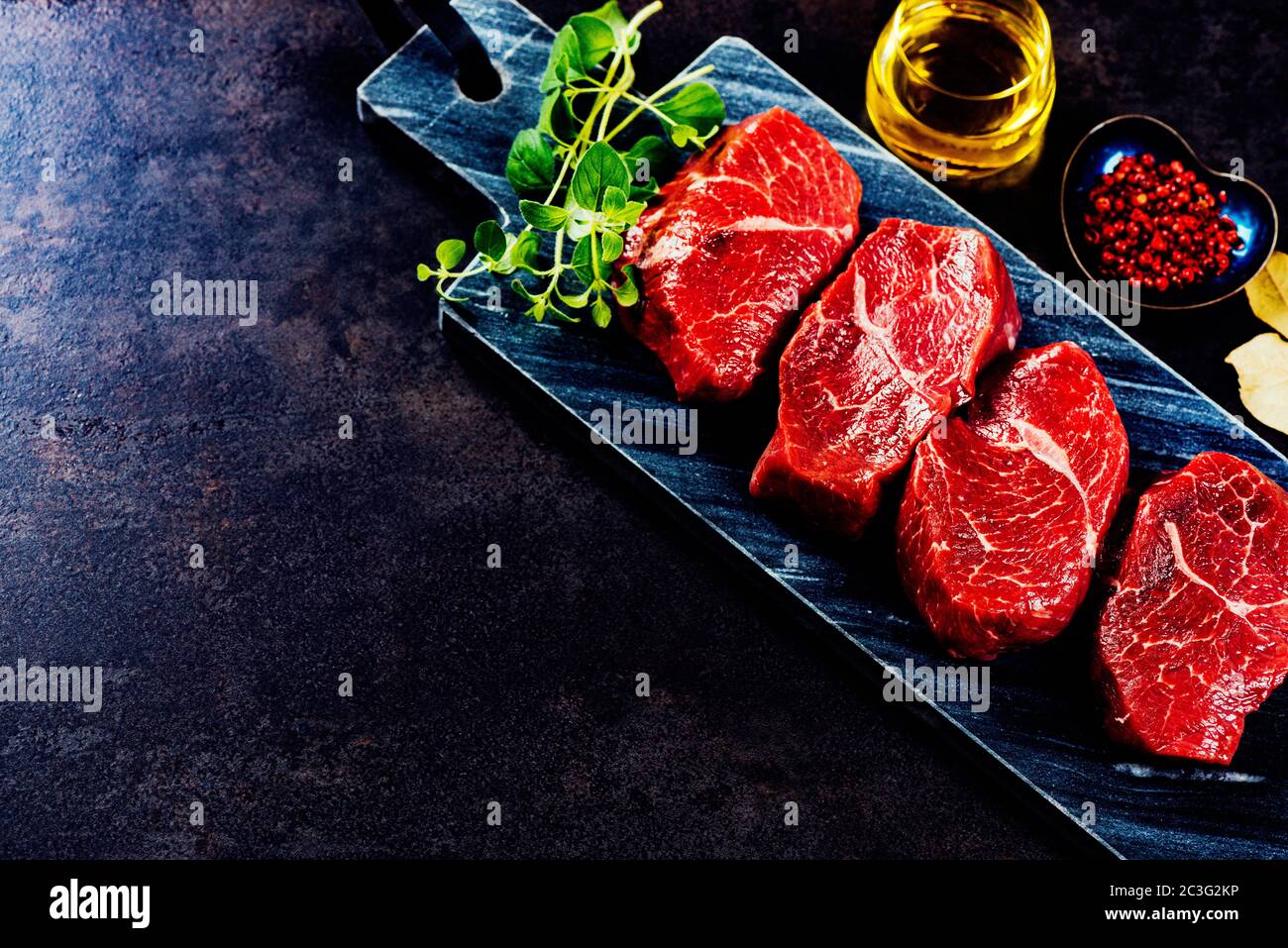 Beef steaks on cutting board Stock Photo