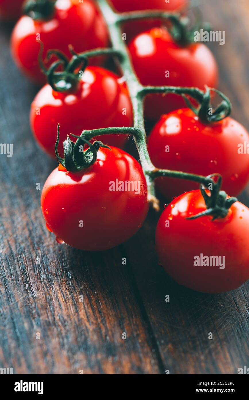 cherry tomatoes on vine Stock Photo