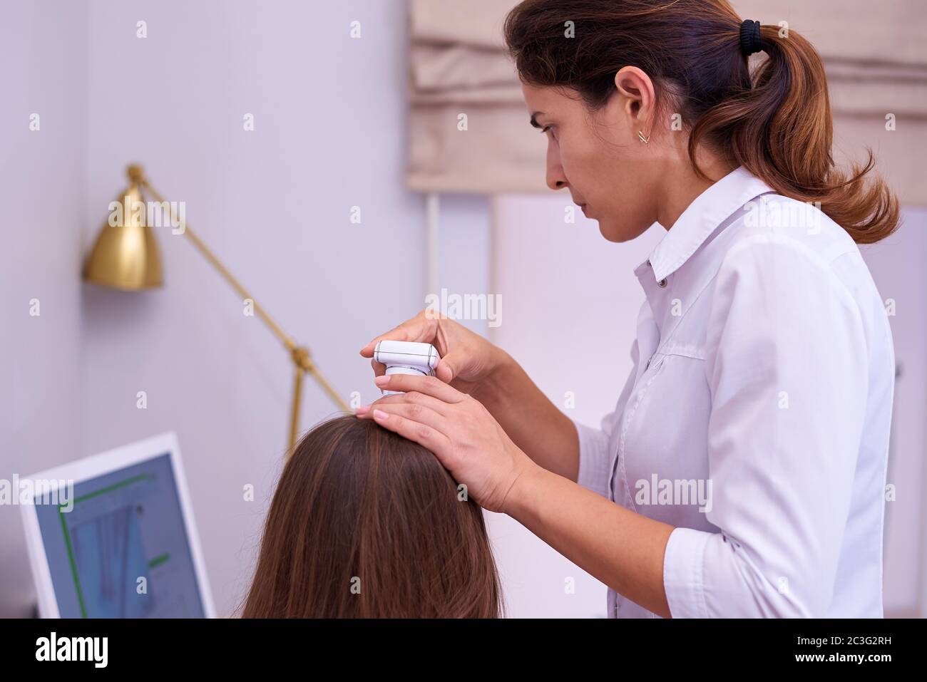 Microscopic examination of the hair and skin of the scalp Stock Photo