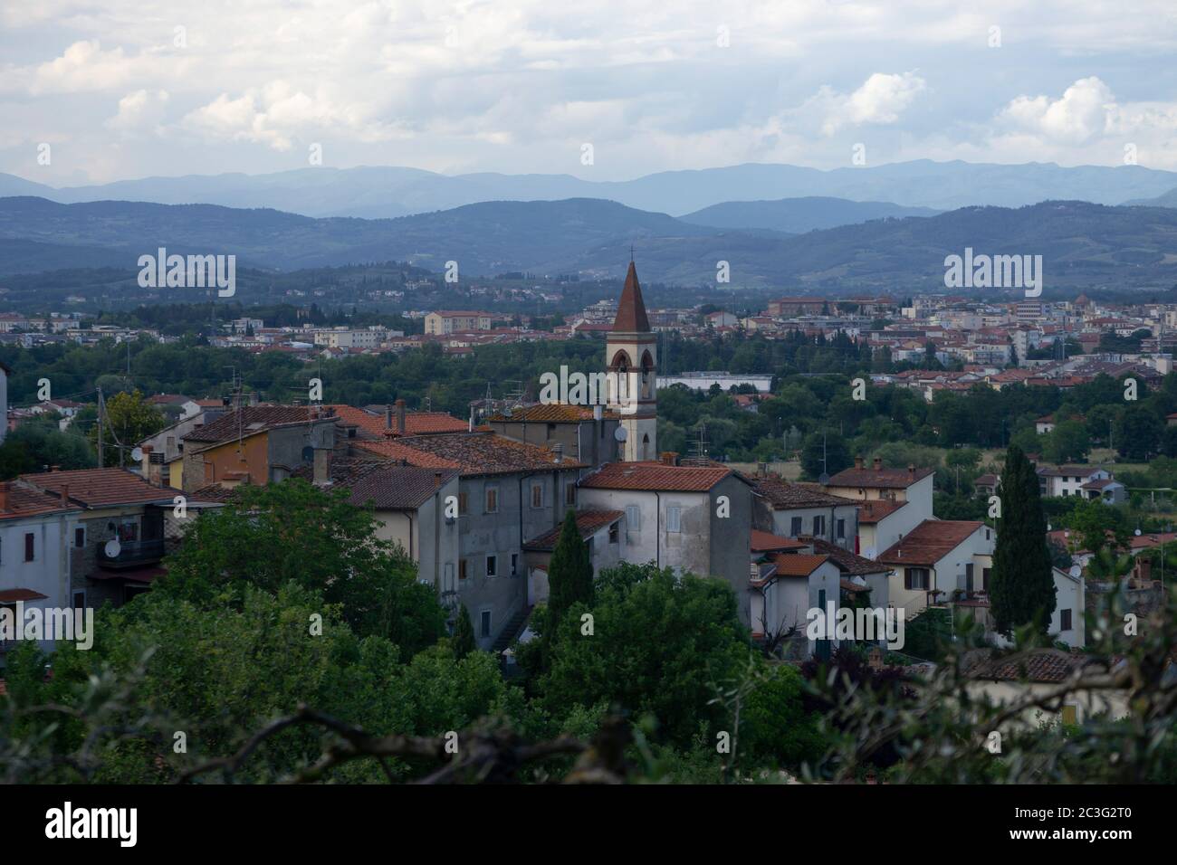 scenic view of a typical village in the Tuscan countryside with a bell tower in evidence on background of Arezzo town Stock Photo